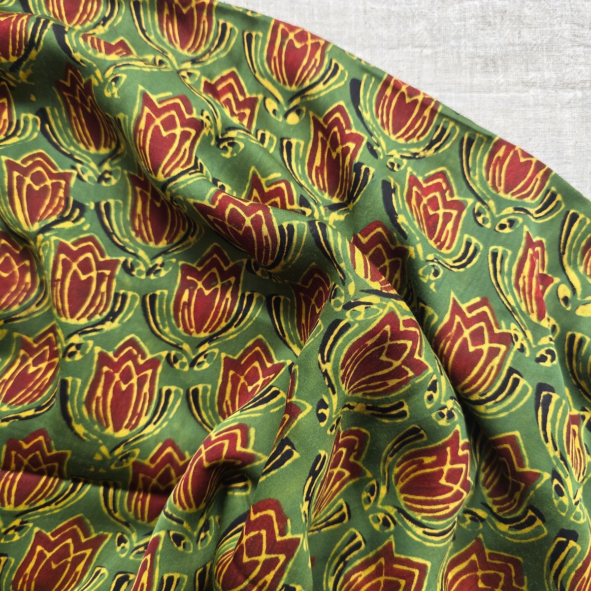 Modal Silk Green With Rust Red Lotus Motif Fabric